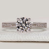 Round cut engagement ring with tapered pavé shank
