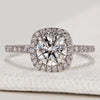Round cut engagement ring with halo and pavé style.
