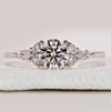 Round cut ring with marquise and round side stones.