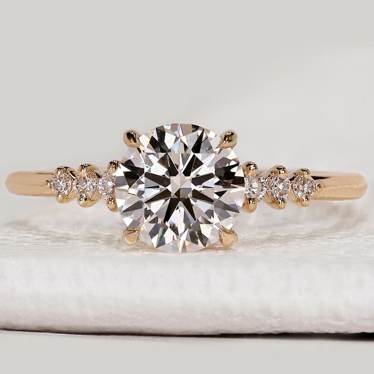 Round cut diamond ring with seven stone setting.