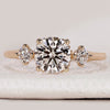 Round cut three stone ring with hidden halo design.