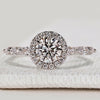 Round cut ring with halo and marquise pavé style.