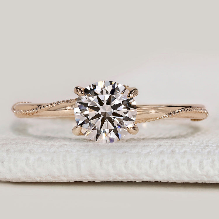 Round cut solitaire ring with hidden stones setting
