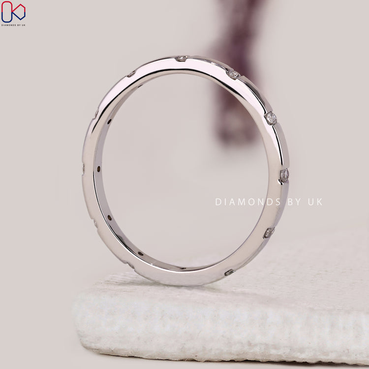 Diamond birthstone wedding band designed in a minimalist style with hidden detail.
