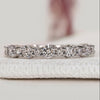 Round cut diamond wedding band with half eternity style.