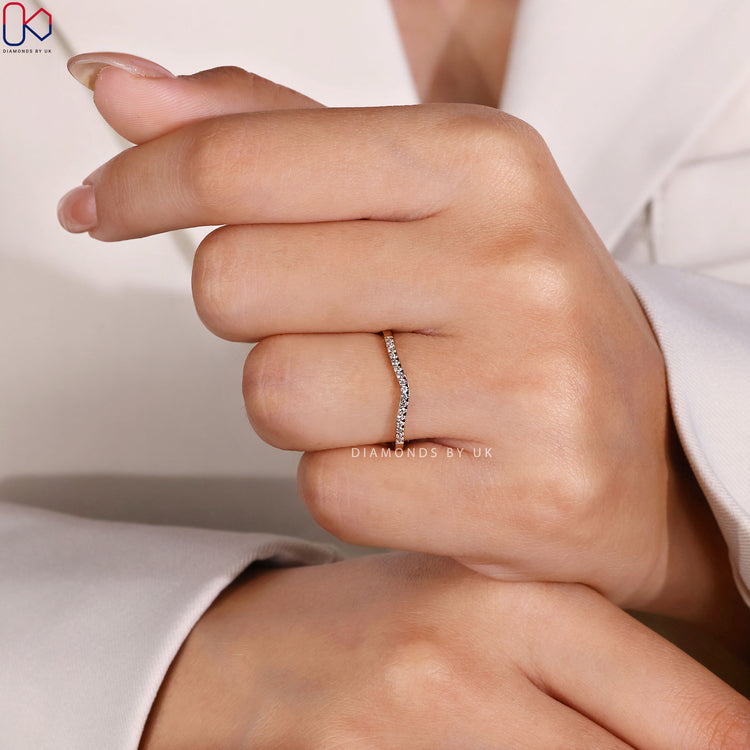 Diamondsbyuk curved diamond band with round stones.