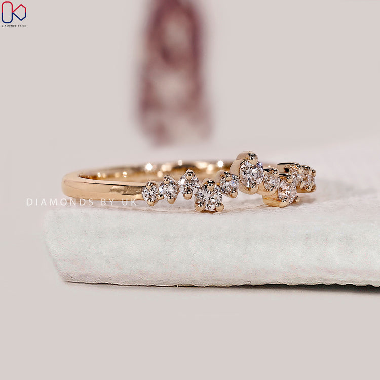Stackable diamond wedding band with tiny diamonds in a half eternity layout.
