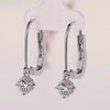 Round diamond earrings with dangle and drop style.