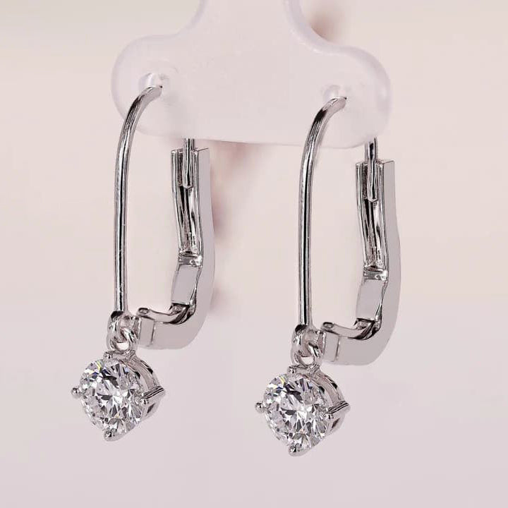 Round diamond earrings with dangle and drop style.