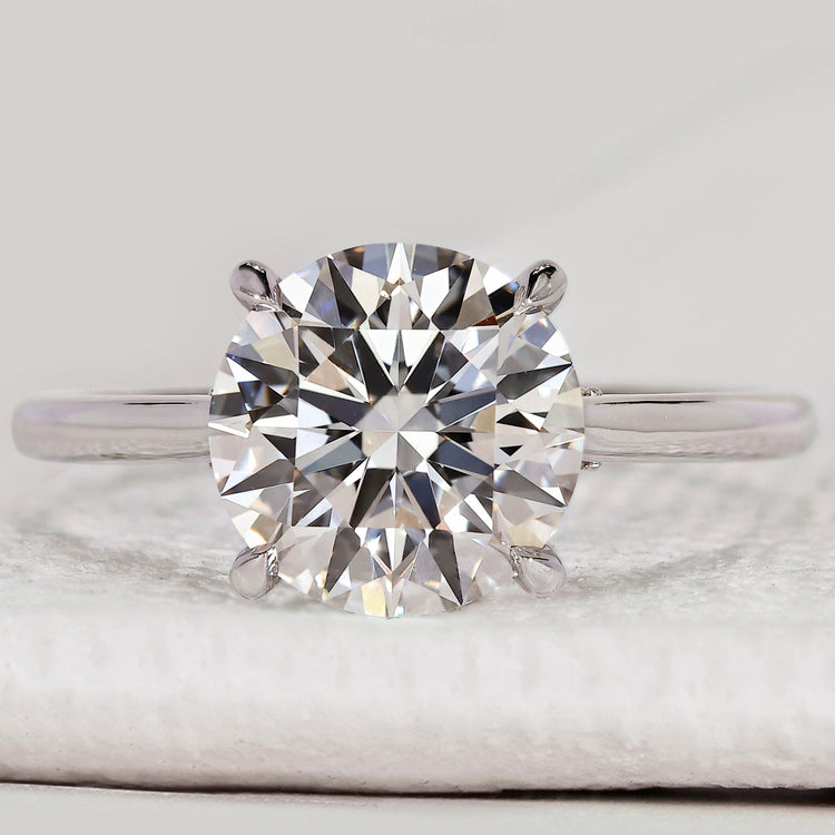 Round diamond engagement ring with hidden halo.