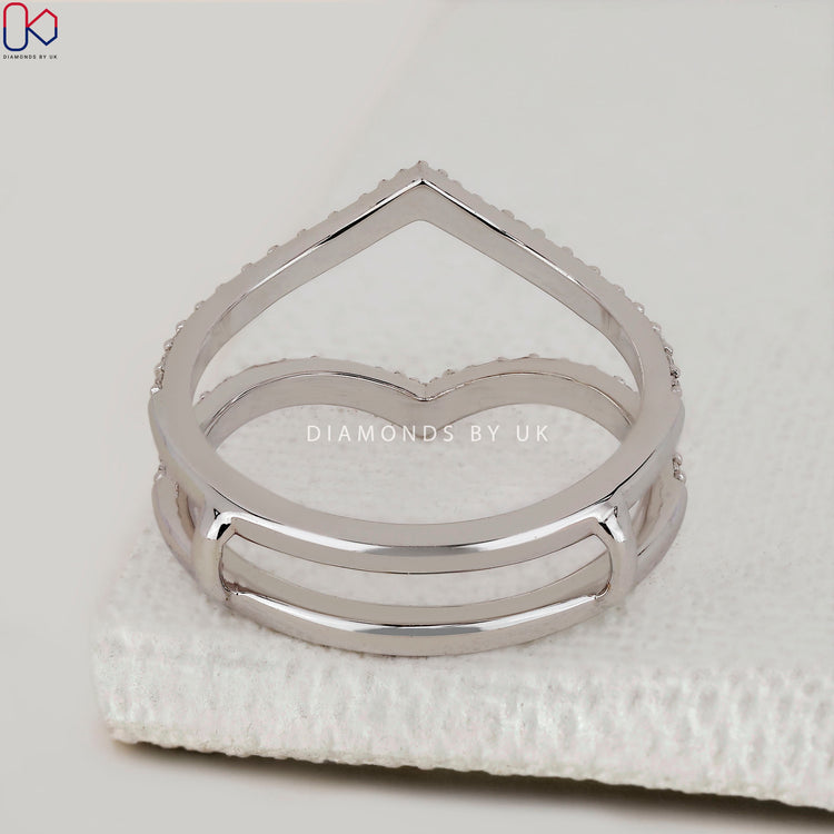 White gold ring enhancer featuring prong set lab diamonds in a curved form.
