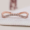Round diamond wedding band with eternity wave style.
