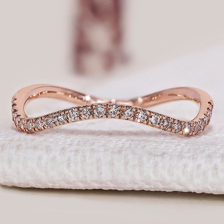 Round diamond wedding band with eternity wave style.
