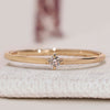 Round diamond wedding band with solitaire style.
