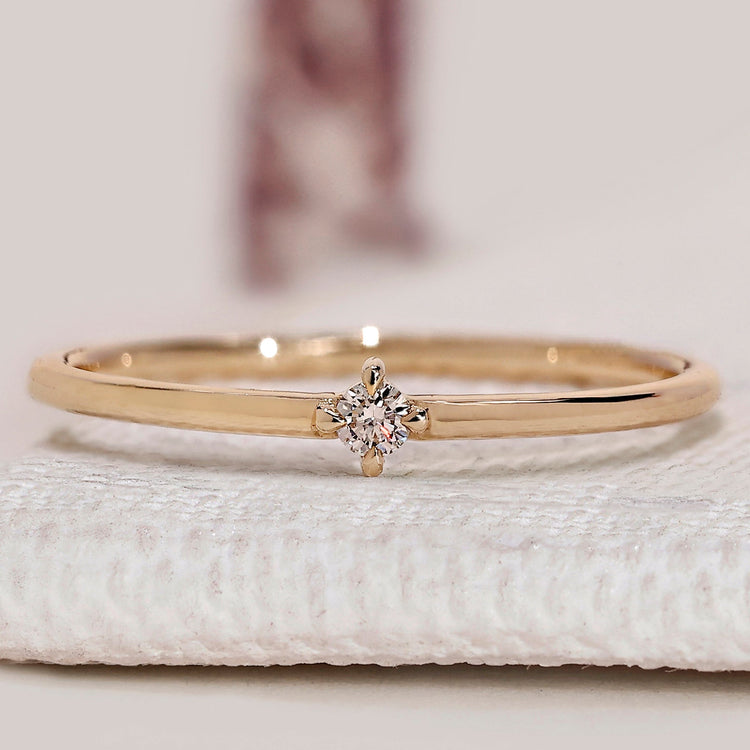 Round diamond wedding band with solitaire style.
