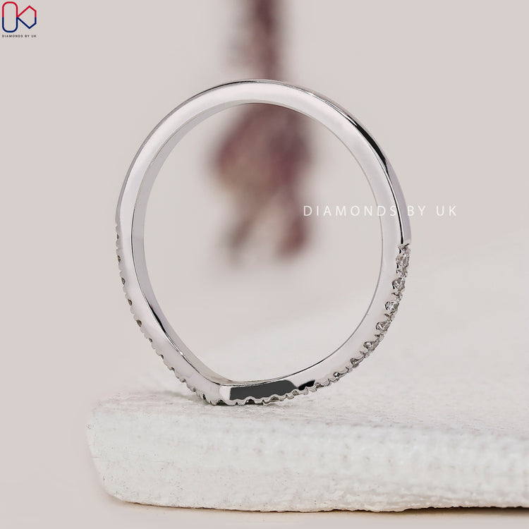 Half eternity diamond wedding band designed with round lab diamonds in a V shape.
