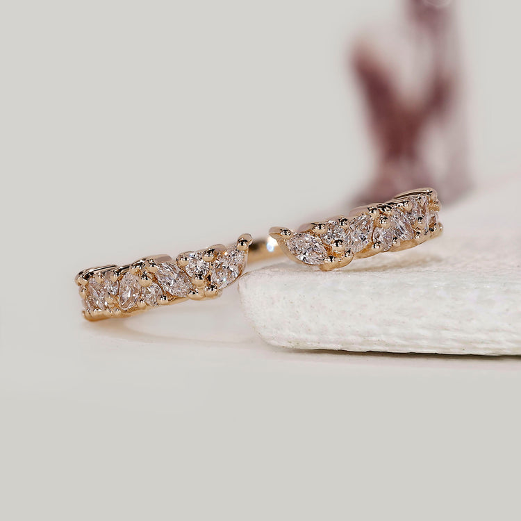 Marquise and round diamond wedding band crafted with a modern open structure.
