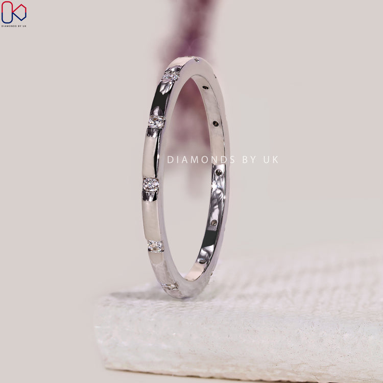 Gypsy setting wedding band handmade with round diamonds set flush in white gold.
