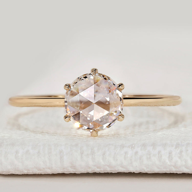 Round rose cut solitaire ring with six claw setting.
