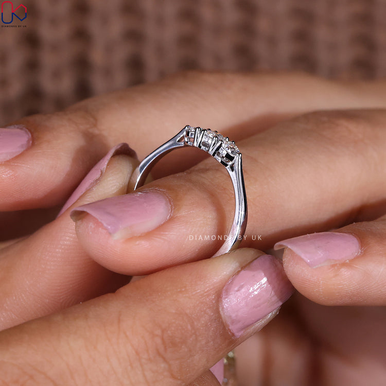 Handmade band with three round diamonds set in white gold.
