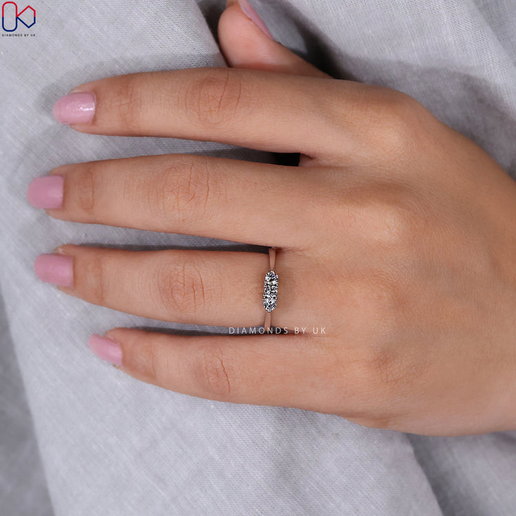 Custom wedding band featuring three round lab grown diamonds.
