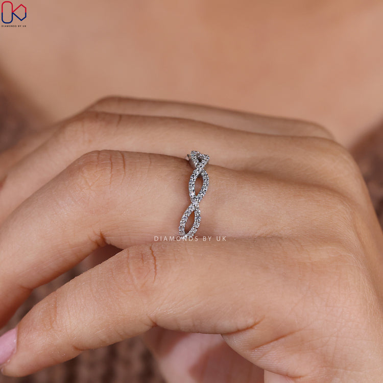 Buy diamond band with round cut stones set by skilled artisans.
