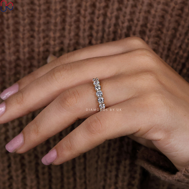 Prong set diamond band made in radiant yellow gold finish.
