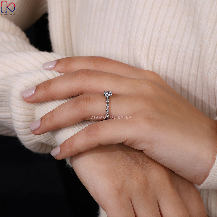 Floating bubble prong ring with round diamond center.
