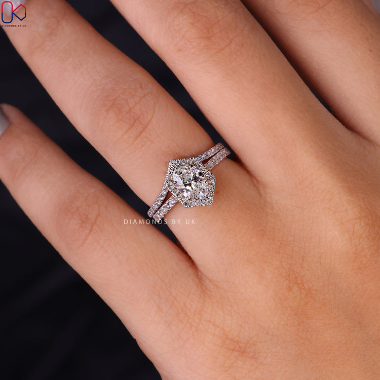 Curved diamond band in a white gold bridal set with halo engagement ring.
