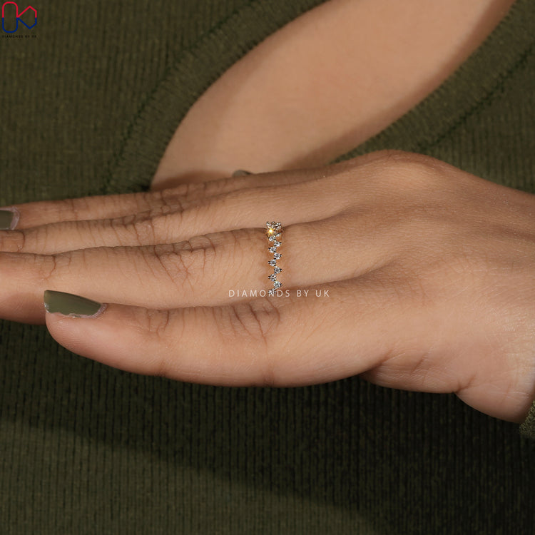 Anniversary band with zig zag design and prong set round diamonds.