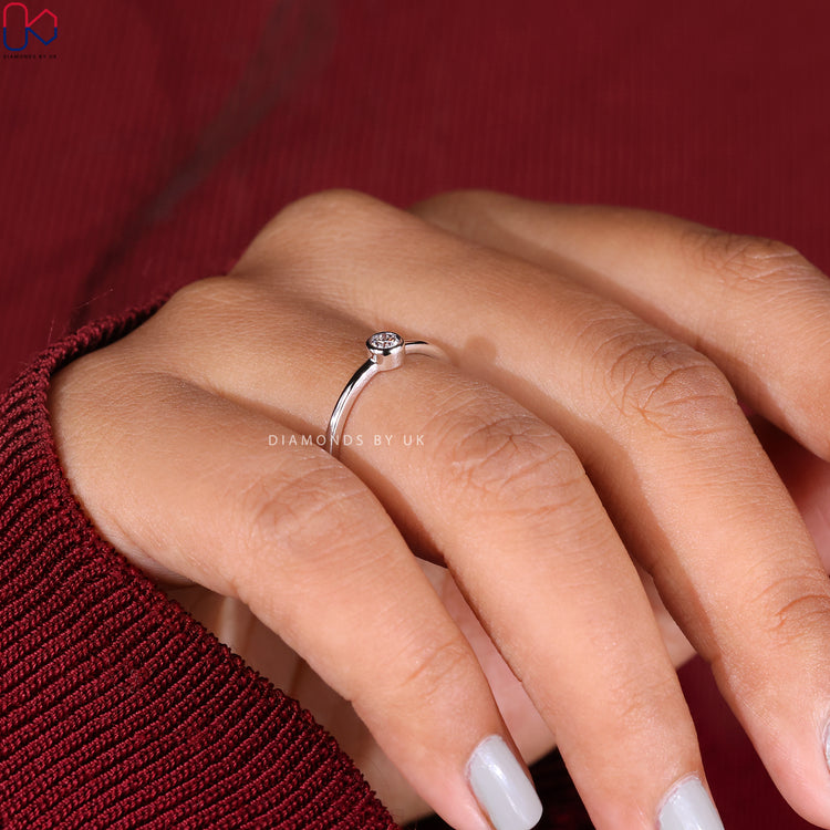 Lab grown diamond set in a bezel engagement ring.
