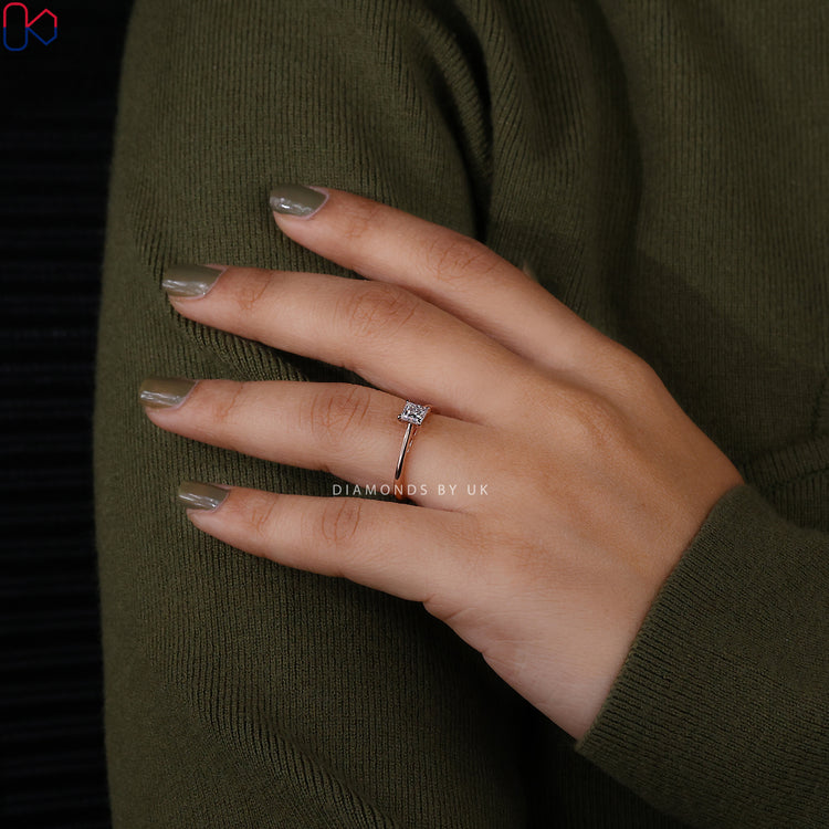 Rose gold ring featuring princess cut diamond solitaire.