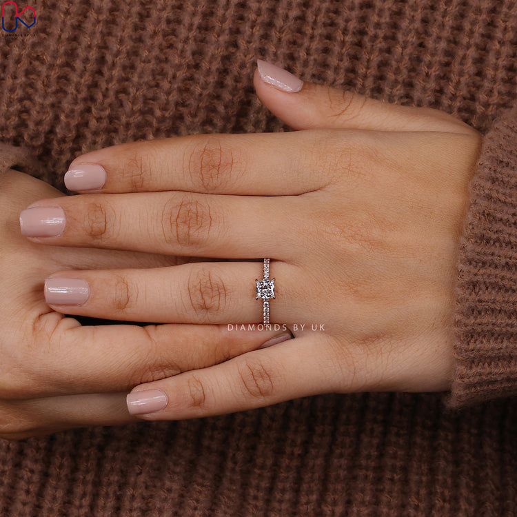 Elegant princess diamond ring with round cut side stones.