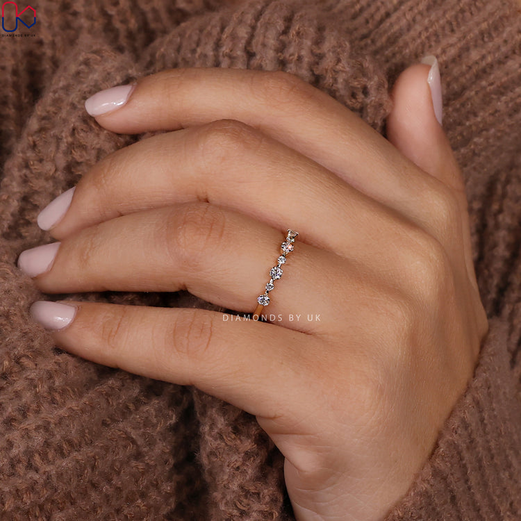 Yellow gold wedding band with shared prong diamond setting.
