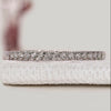 Semi eternity wedding band with round diamonds.