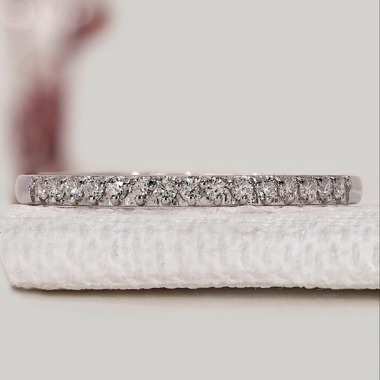 Semi eternity wedding band with round diamonds.