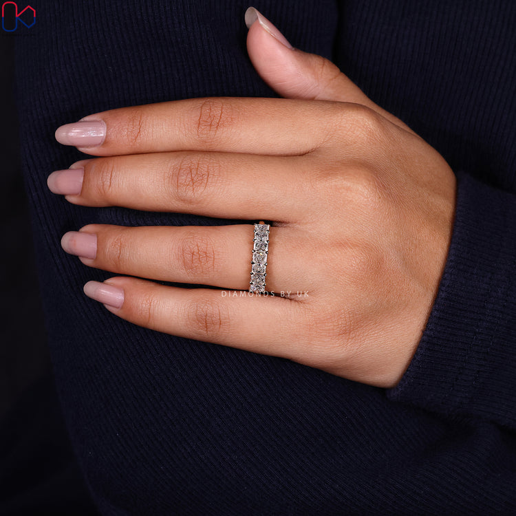Stackable wedding band designed with seven radiant diamonds in a handcrafted finish.
