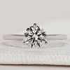 Round diamond solitaire ring with three prong setting.
