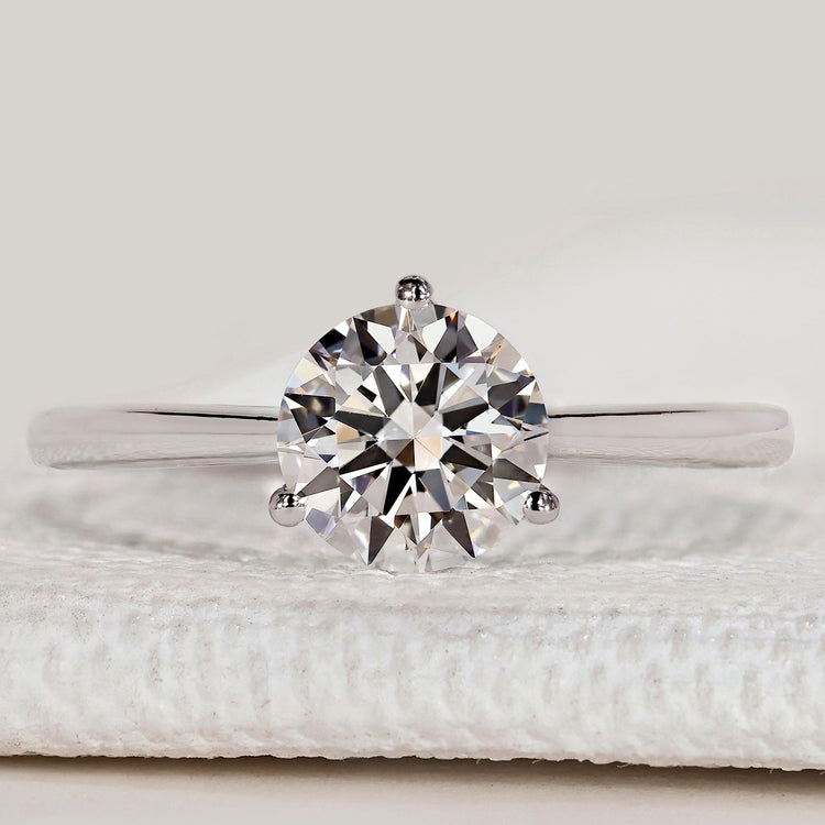 Round diamond solitaire ring with three prong setting.
