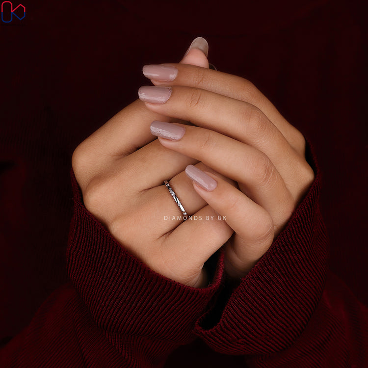 Wedding band for women crafted with round diamonds and a gypsy-style layout.
