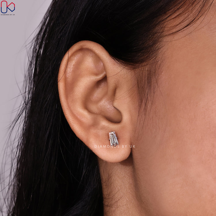 Tapered baguette diamond studs with solitaire style.
