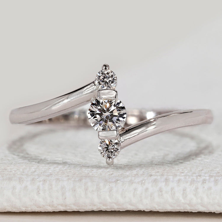 Three stone ring with round diamond bypass setting.
