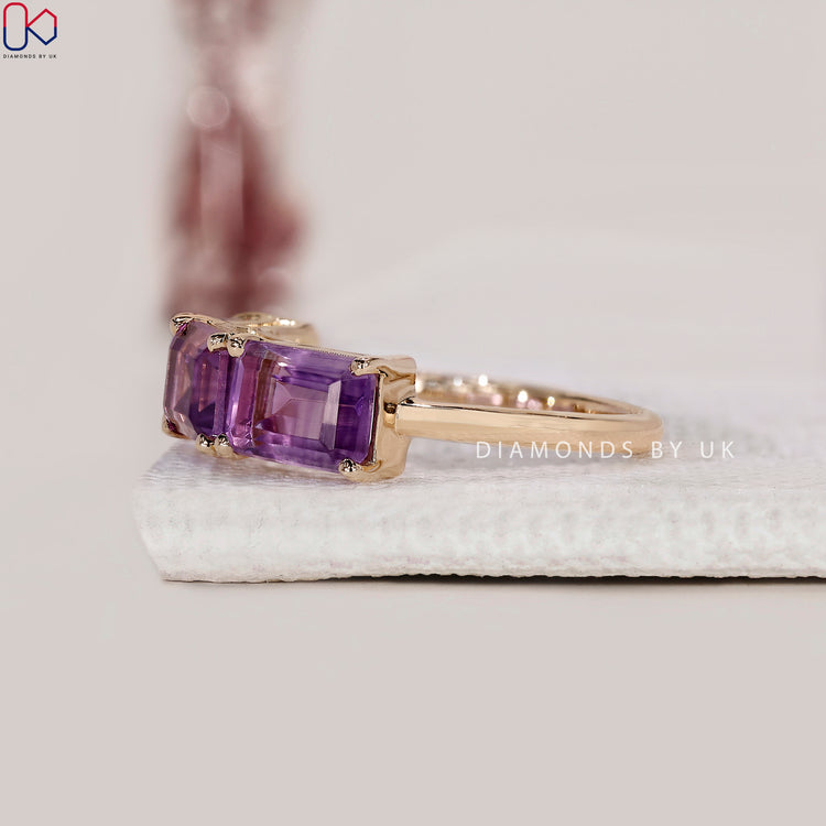 Handmade yellow gold ring featuring emerald cut amethyst