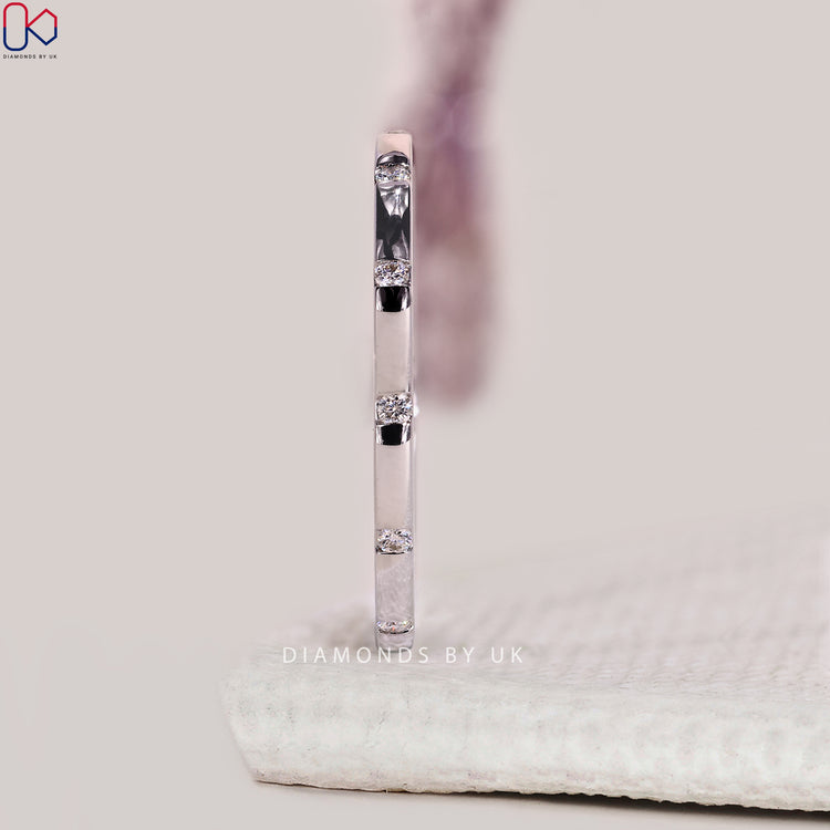 Flush set wedding band with round lab diamonds embedded for a smooth profile.
