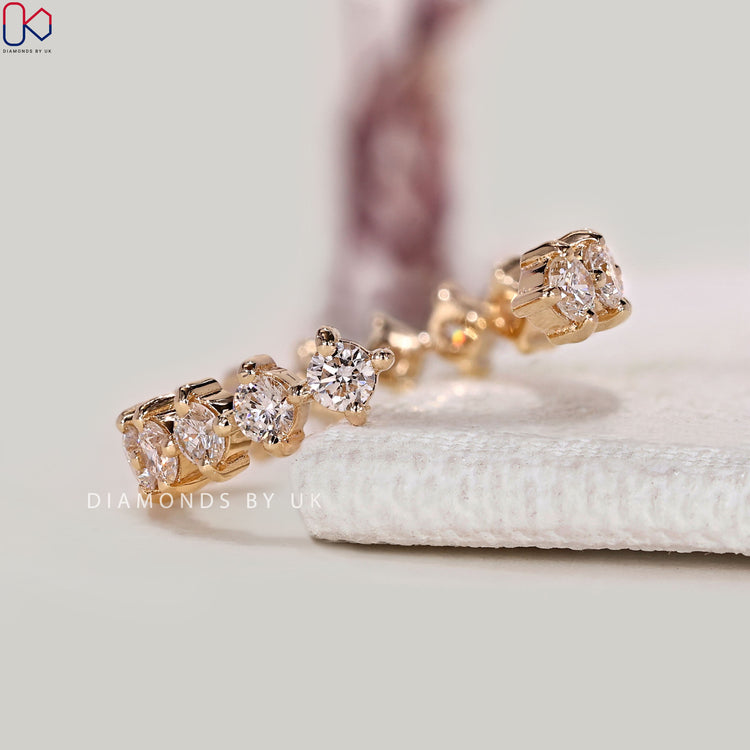 Round diamond wedding band with compass prong setting.