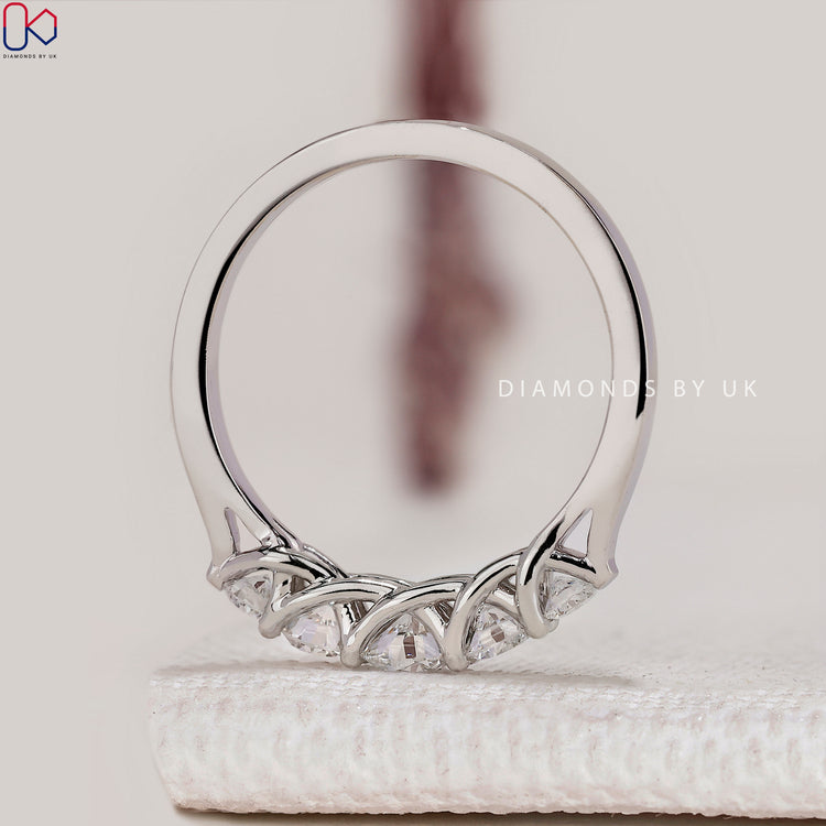 Five stone round diamond wedding band with trellis setting.