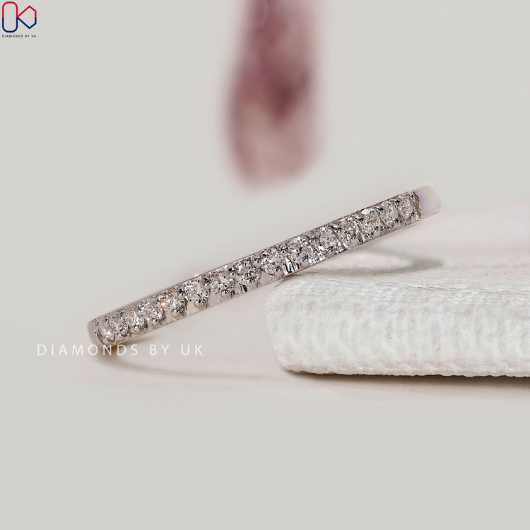 Round diamond semi eternity band with prong setting.