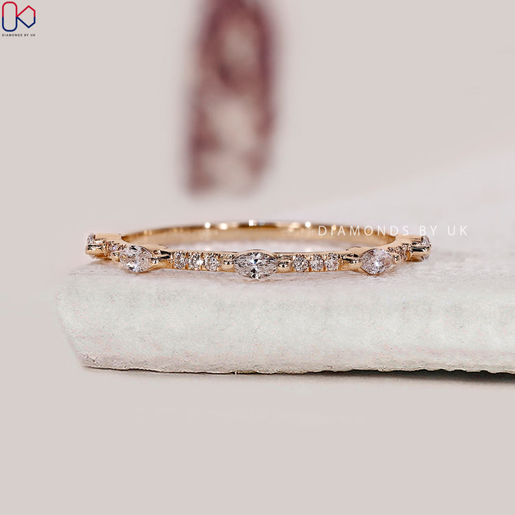 Marquise diamond wedding band designed with alternating stones for a soft, graceful curve.

