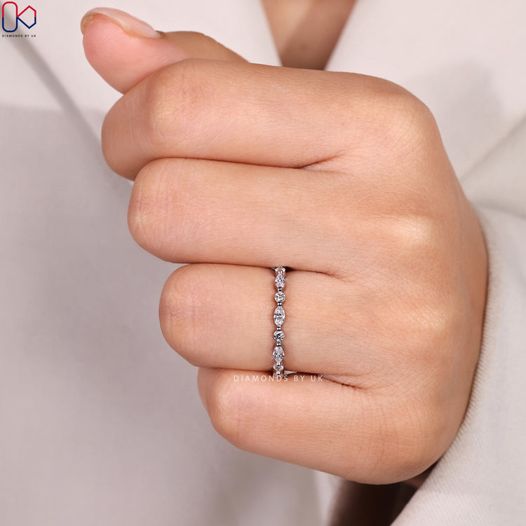 Shared prong marquise and round diamond wedding band.
