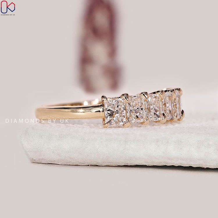 Seven diamond wedding band made in yellow gold for a classic half eternity design.
